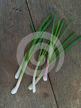 Close Up of Fresh Young Red Onions on Wooden Surface