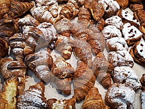 Close-up of freshly baked buns and croissants on a store counter