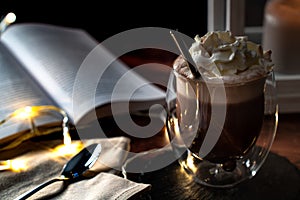 Close-up of a freshly brewed cup of cacao topped with a dollop of whipped cream