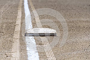 Close up of freshly chalked baseline, with base plate, dirt only, empty baseball field on a sunny day