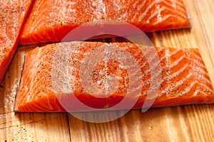 Close up of freshly cut raw red trout fillets, also known as arc