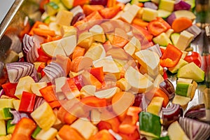 Close up of freshly diced Mediterranean vegetables ready for oven baking