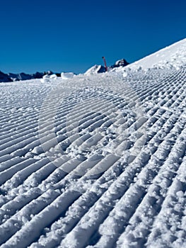 A close up of freshly groomed snow slope