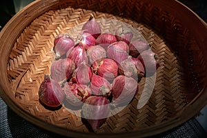 Close up freshly red onions in a rattan basket for seasoning