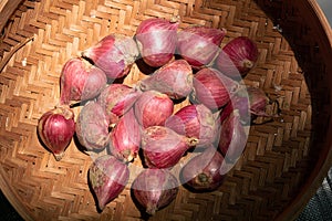 Close up freshly red onions in a rattan basket for seasoning