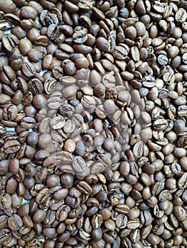 Close-up of freshly roasted brown aromatic coffee beans.