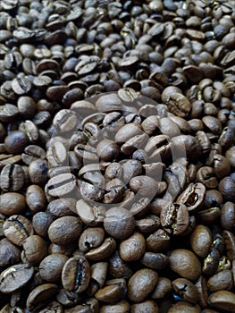 Close-up of freshly roasted brown aromatic coffee beans.