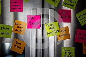 Close Up of Fridge Door With Reminder Notes Reminding to File Taxes April 15th