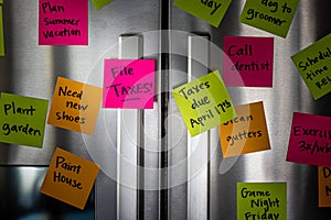 Close Up of Fridge Door With Reminder Notes Reminding to File Taxes April 17th