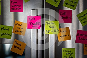 Close Up of Fridge Door With Reminder Notes Reminding to File Taxes April 18th