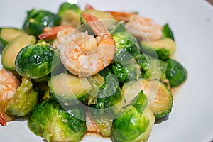 Close up, Fried Brussels Sprouts or Brassica oleracea  with fresh shrimp on plate
