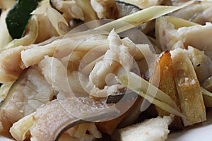 Close-up fried freshness squid and fried anchovies in Sitges - pescadito frito, chipirones fritos at traditional gourmet