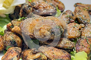 Close up of fried mussels with fresh spices.