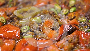 Close-up of fried potatoes in oil. Clip. Roasted potato in a frying pan, close up view. Roast, frying pan, background