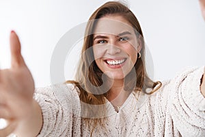 Close-up friendly outgoing good-looking charming woman welcoming wanna embrace you extend arms towards camera smiling