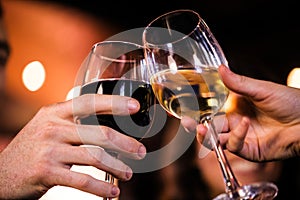 Close up of friends toasting with wine