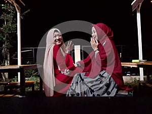 Close-up of friendship of two Muslim women sitting in the park