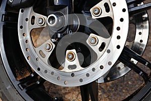 A close up of a front disc brake of a motorcycle