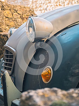 A close-up of the front of an old Citroen 2 CV, headlamp and hood in the first frame.