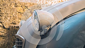 A close-up of the front of an old Citroen 2 CV, Vintage car