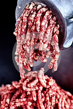 Close up front part of mincing-machine with forcemeat in
