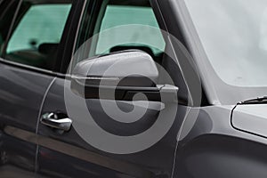 Close up front view of car side mirror. Front rear view mirror on the car window.