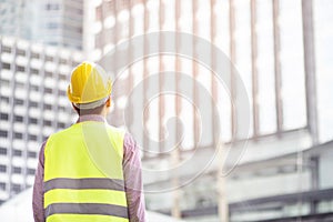 Close up front view of engineering male construction worker stand holding safety