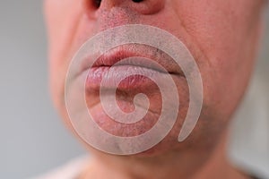 Close-up and front view of mouth of an old caucasian man in his sixties, with strong wrinkles, bright emotions on his face, male