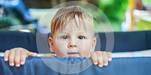 Close-up front view portrait of cute baby boy. Outdoor summer time