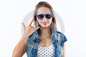 Close-up front view portrait of a gorgeous, glamorous model presenting funny high-fashion look in studio.