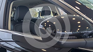 Close-up front view of rearview mirror and modern car interior. A rear view mirror on a car door