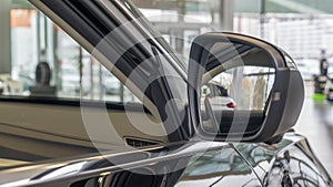 Close-up front view of rearview mirror and modern car interior. A rear view mirror on a car door