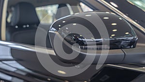 Close-up front view of rearview mirror and modern car interior. A rear view mirror on a car door