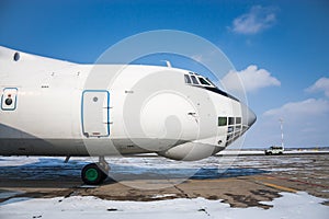 Close-up front view of widebody cargo airplane in a cold winter airport photo