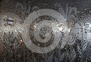 Close-up of frosted glass with floral pattern