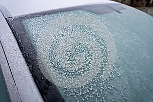 Close up of frozen car front windshield in winter