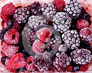 Close up of frozen mixed fruit - berries - red currant, cranberry, raspberry, blackberry, bilberry, blueberry, black currant