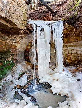 Close-up of frozen waterfalls on rocks with icicles in Latvia.