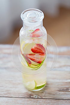 Close up of fruit water in glass bottle