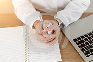 Close up frustrated hands business crumpling paper ball