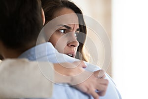 Close up frustrated woman hugging man, thinking about relationship problems