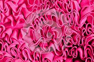 Close up on fuchsia pink wavy fabric.