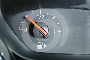 Close up of a fuel gauge showing a quarter full fuel tank in a car, gasoline consumption.