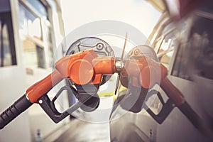 Close up of fuel monitoring system refueling a petroleum to vehicle at gas station