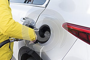 Close-up fuel nozzle with hand hold . Fill up fuel at gas station.
