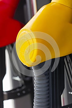 Close-up fuel nozzles on petrol and diesel fuel. Gas station pump. Man refueling gasoline with fuel in a car, holding a nozzle.