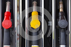 Close-up fuel nozzles on petrol and diesel fuel. Gas station pump. Man refueling gasoline with fuel in a car, holding a nozzle.