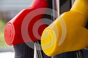 Close-up fuel nozzles on petrol and diesel fuel. Gas station pump. Man refueling gasoline with fuel in a car, holding a nozzle.