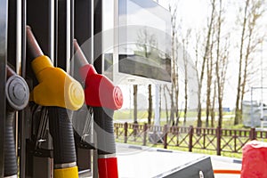 Close-up fuel nozzles on petrol and diesel fuel. Gas station pump. Man refueling gasoline with fuel in a car, holding a nozzle.