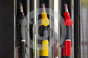 Close-up fuel nozzles on petrol and diesel fuel. Gas station pump. Man refueling gasoline with fuel in a car, holding a nozzle.